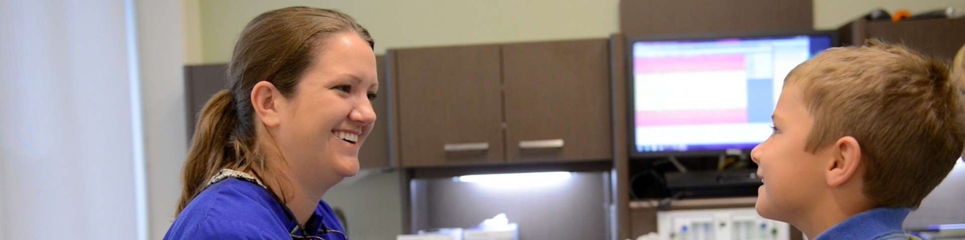 Dental Assistant helping young patient